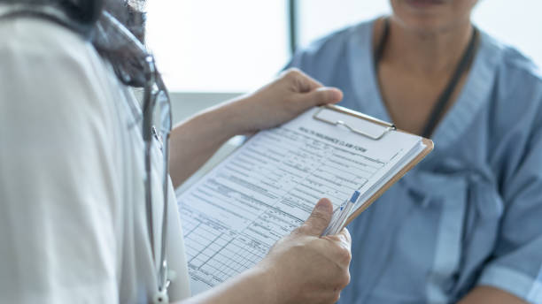 Paperwork and a patient being seen in a medical office